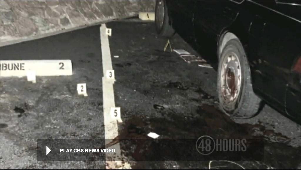View showing five police markers of bloody shoe prints at crime scene. Marker 1 is located at the arrow. Modified still from CBS News video.