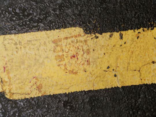 Bloody shoe print heel found at police marker 3 in jog in yellow painted lane stripe. CBS News photo
