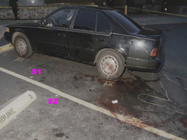 View of crime scene on driver side of Heitholt Maxima after removal of body and loose items on pavement. The chalk outline denotes the relative location of the victim’s body before removal. Both wheels have been chalk marked for their position on the pavement in preparation for removal of the vehicle. Note the blood on the pavement and on the left rear wheel rim and cover. S1 locates pavement scuff marks possibly made by the victim during the attack. S2 locates apparent rotational scuff marks possibly made by victim or killer during the attack. Modified Crime scene photo found on CBS news Internet site. Several of the following photos were made prior to this photo.