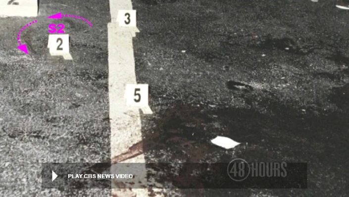 View of pavement to either side of yellow stripe. Note the possible rotational scuff markings at S2 as denoted in an earlier photo. The direction of rotation appears counterclockwise. Modified still of CBS News police video.