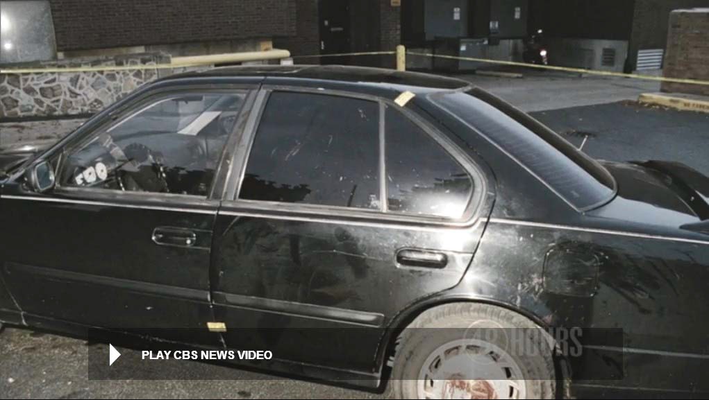 Still from police video showing driver side of Heitholt Maxima. Scrub and other contact markings can be readily seen to the left rear door window, left rear door and left quarterpanel as well as left rear wheel. Scrub markings can also be seen to outside of the left front door frame. Still from CBS News video.
